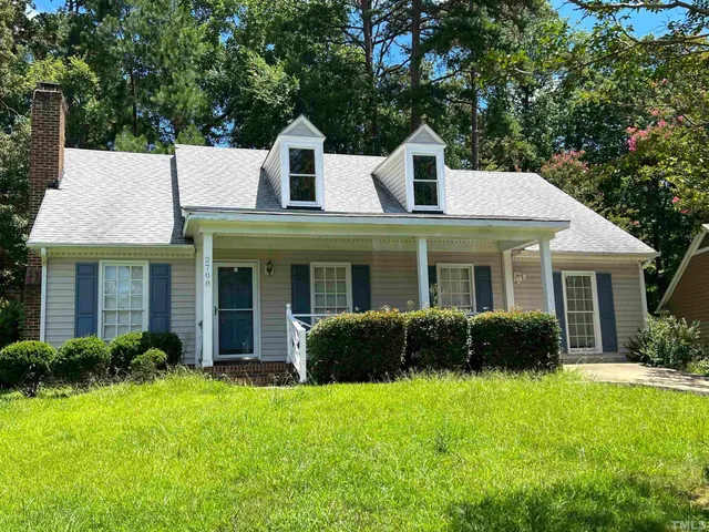 a view of a house with a yard and plants