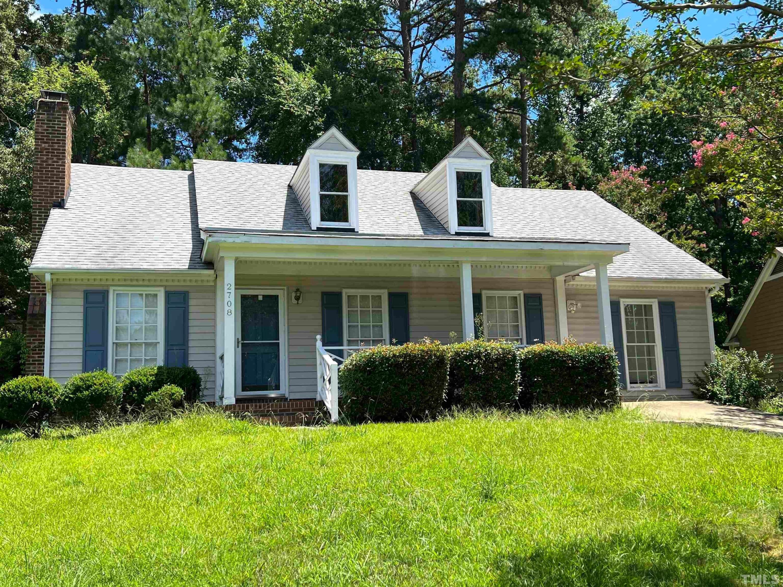 a view of a house with a yard and plants