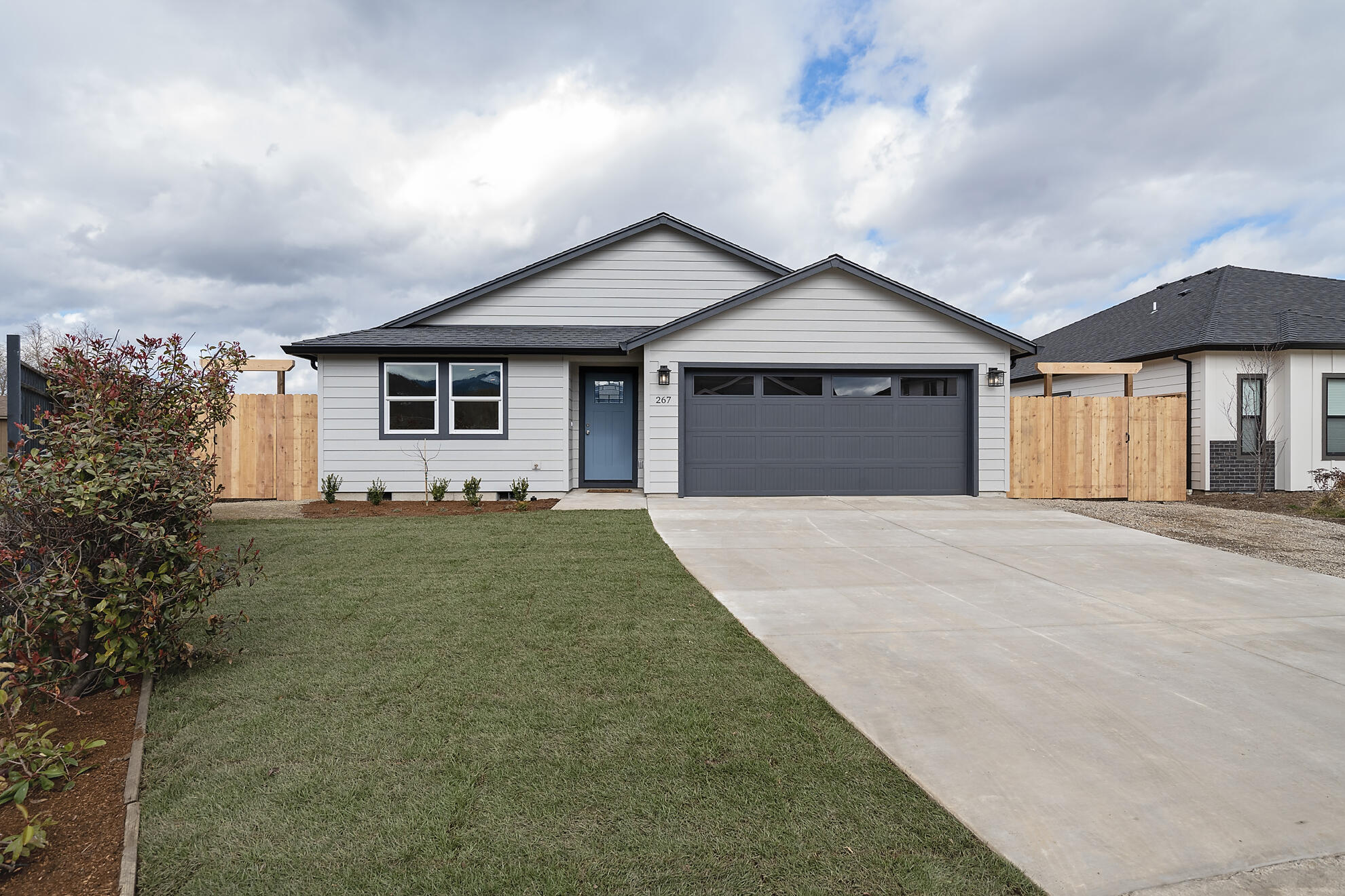 267 Samuel Lane Loop Road Phoenix, OR 97535 - Photo 16 of 16 a front view of a house with a yard and garage
