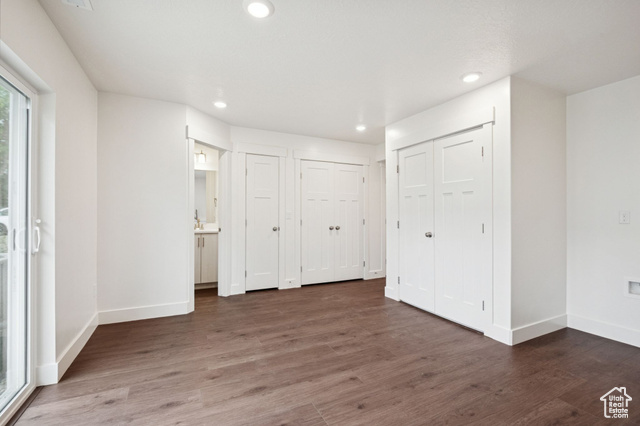 1615 North Angel Street, Unit F Layton, UT 84041 - Photo 6 of 45 Unfurnished bedroom featuring dark wood-style floors, multiple closets, access to exterior, and recessed lighting