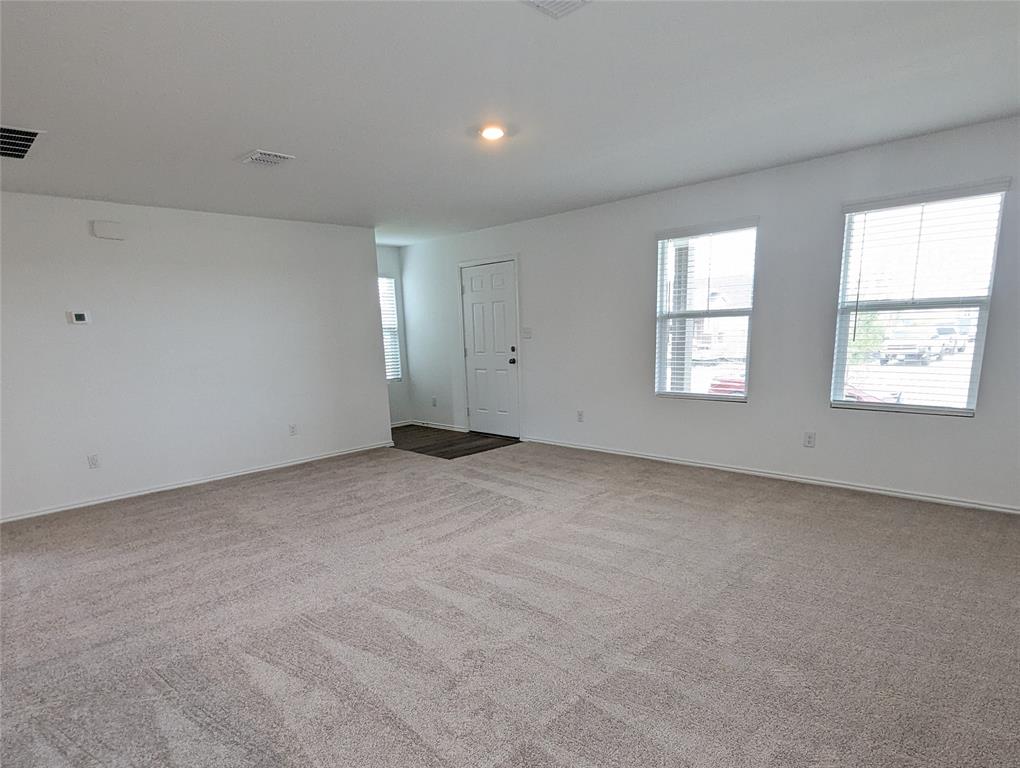 152 Avre Loop Kyle, TX 78640 - Photo 2 of 24 A spacious living area with warm natural light, perfect for relaxation and gatherings.