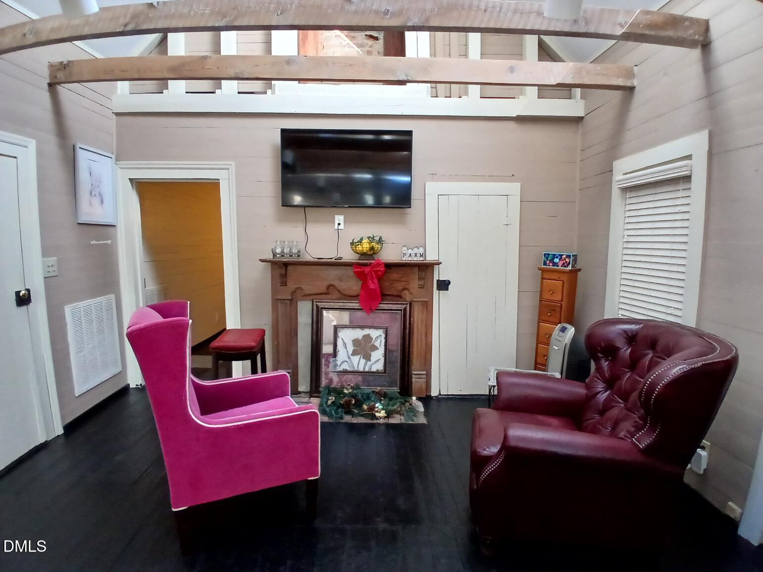 1920 Kelly Road Apex, NC 27502 - Photo 22 of 44 a living room with furniture a flat screen tv and a fireplace