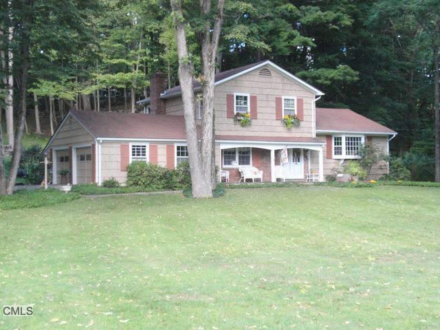 51 Tally Ho Road Ridgefield, CT 06877 - Photo 1 of 1 a front view of a house with a garden and trees