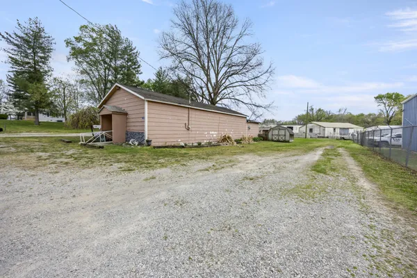 a view of a house with a yard and trees