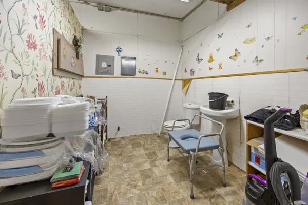 a bathroom with a sink a toilet and shower curtain