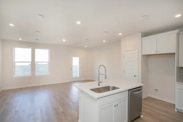 a kitchen with a sink a refrigerator and window
