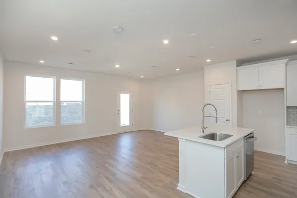 a kitchen with sink and cabinets