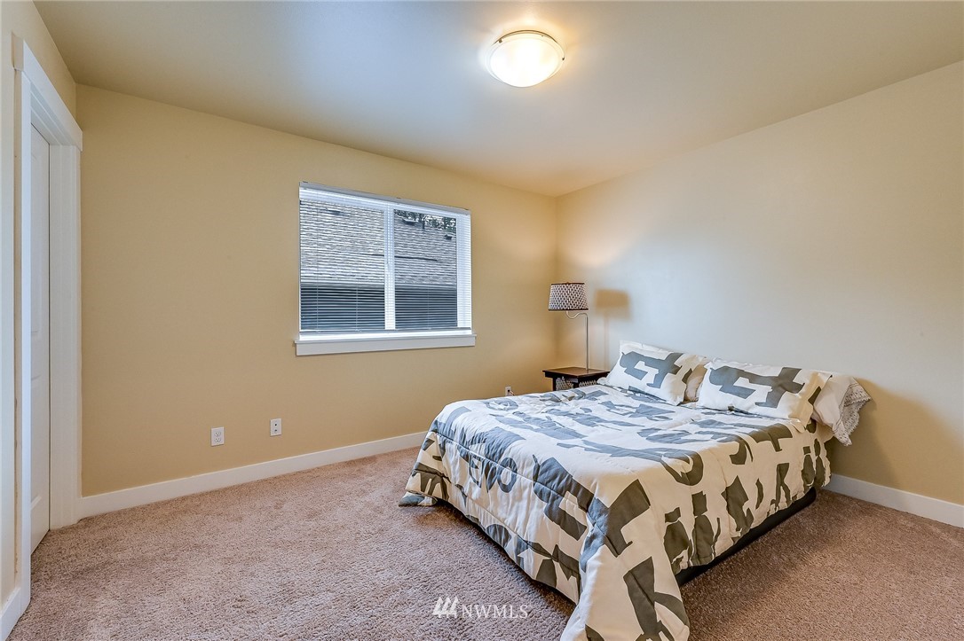 18924 10th Drive Southeast Bothell, WA 98012 - Photo 22 of 28 a bedroom with a bed lamp and a window