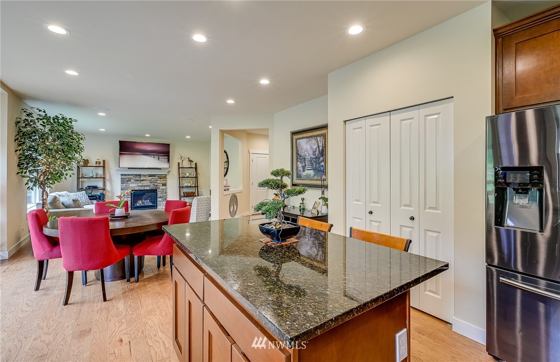 18924 10th Drive Southeast Bothell, WA 98012 - Photo 8 of 28 a kitchen with stainless steel appliances granite countertop a table chairs and a refrigerator