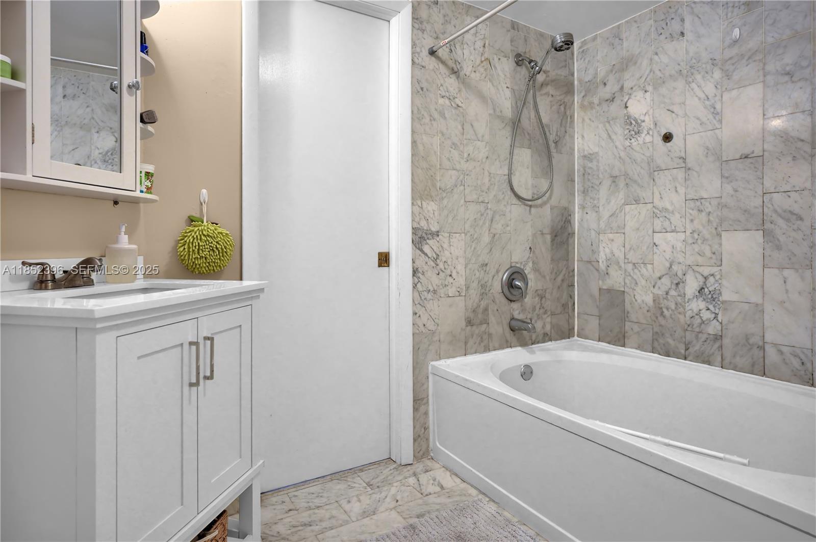 10194 Southwest 77th Court Miami, FL 33156 - Photo 11 of 25 a bathroom with a tub sink vanity and mirror