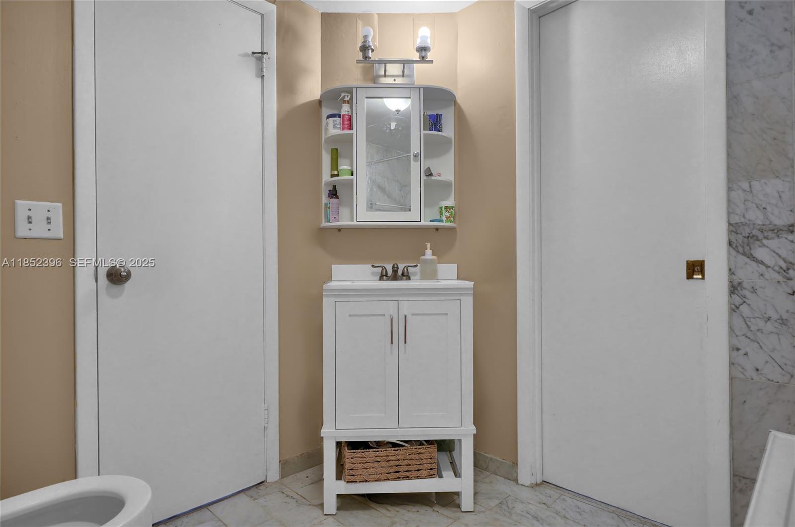 10194 Southwest 77th Court Miami, FL 33156 - Photo 12 of 25 a bathroom with a sink and a mirror