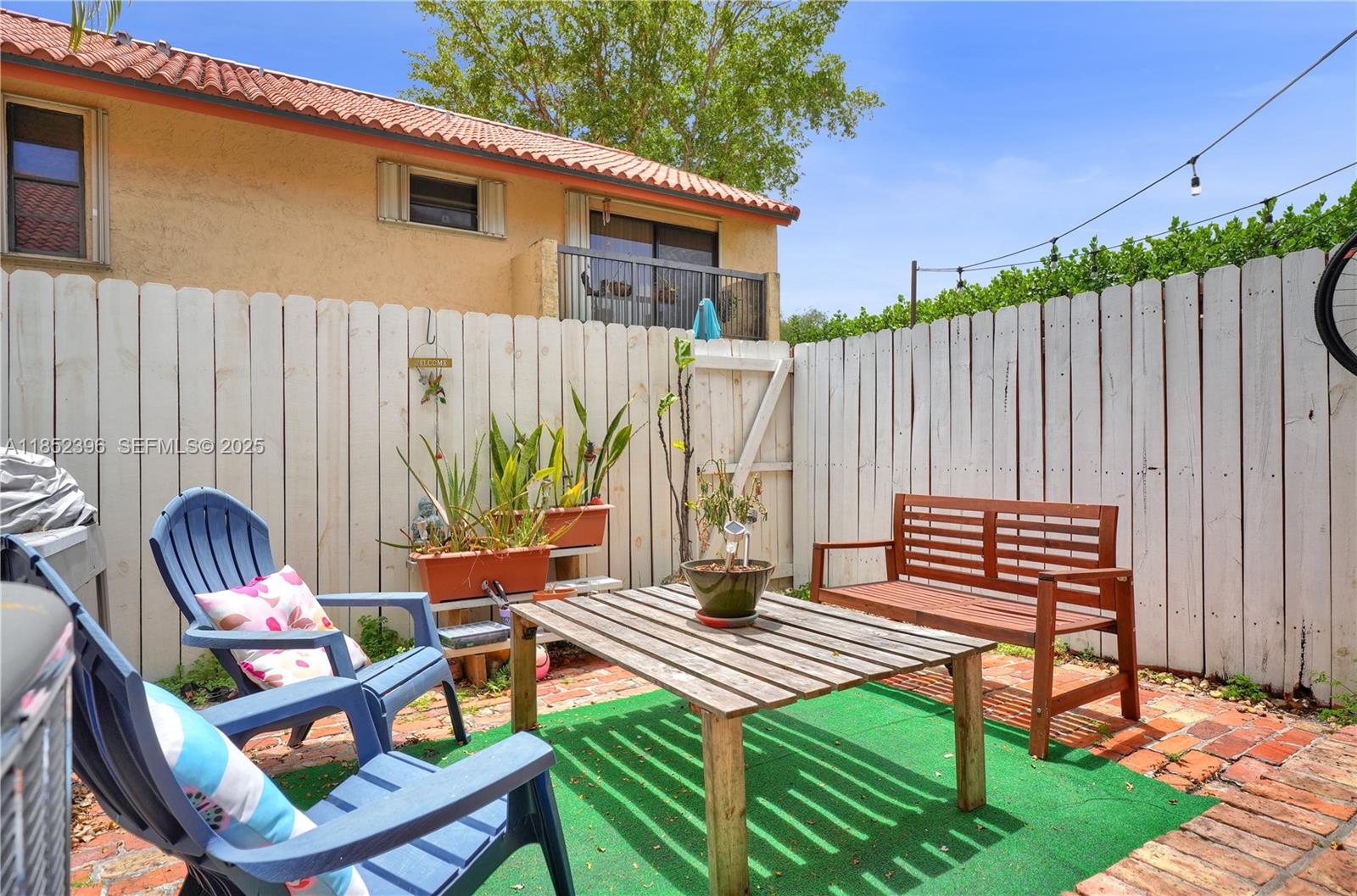 10194 Southwest 77th Court Miami, FL 33156 - Photo 16 of 25 a backyard of a house with barbeque oven table and chairs