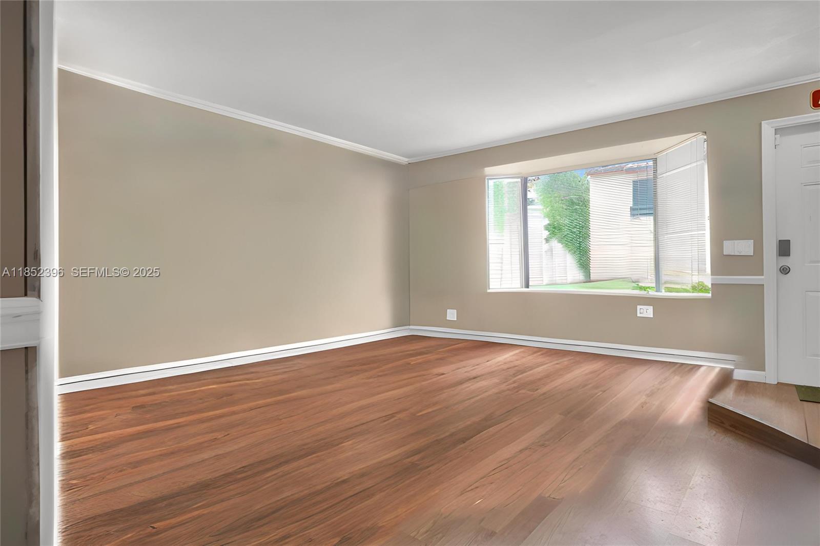 10194 Southwest 77th Court Miami, FL 33156 - Photo 2 of 25 an empty room with wooden floor and windows