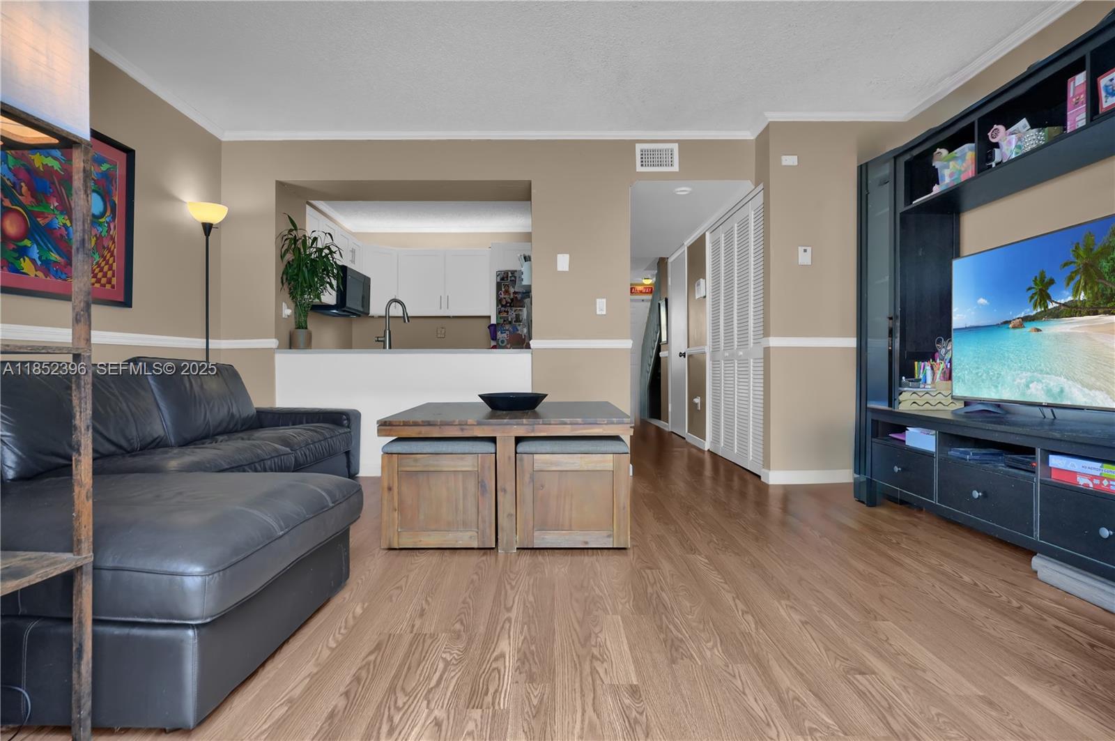 10194 Southwest 77th Court Miami, FL 33156 - Photo 4 of 25 a living room with furniture and a flat screen tv