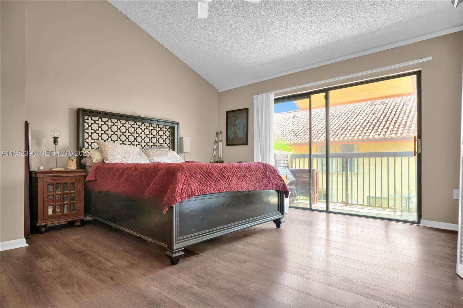 10194 Southwest 77th Court Miami, FL 33156 - Photo 9 of 25 a bedroom with a large bed and a large window