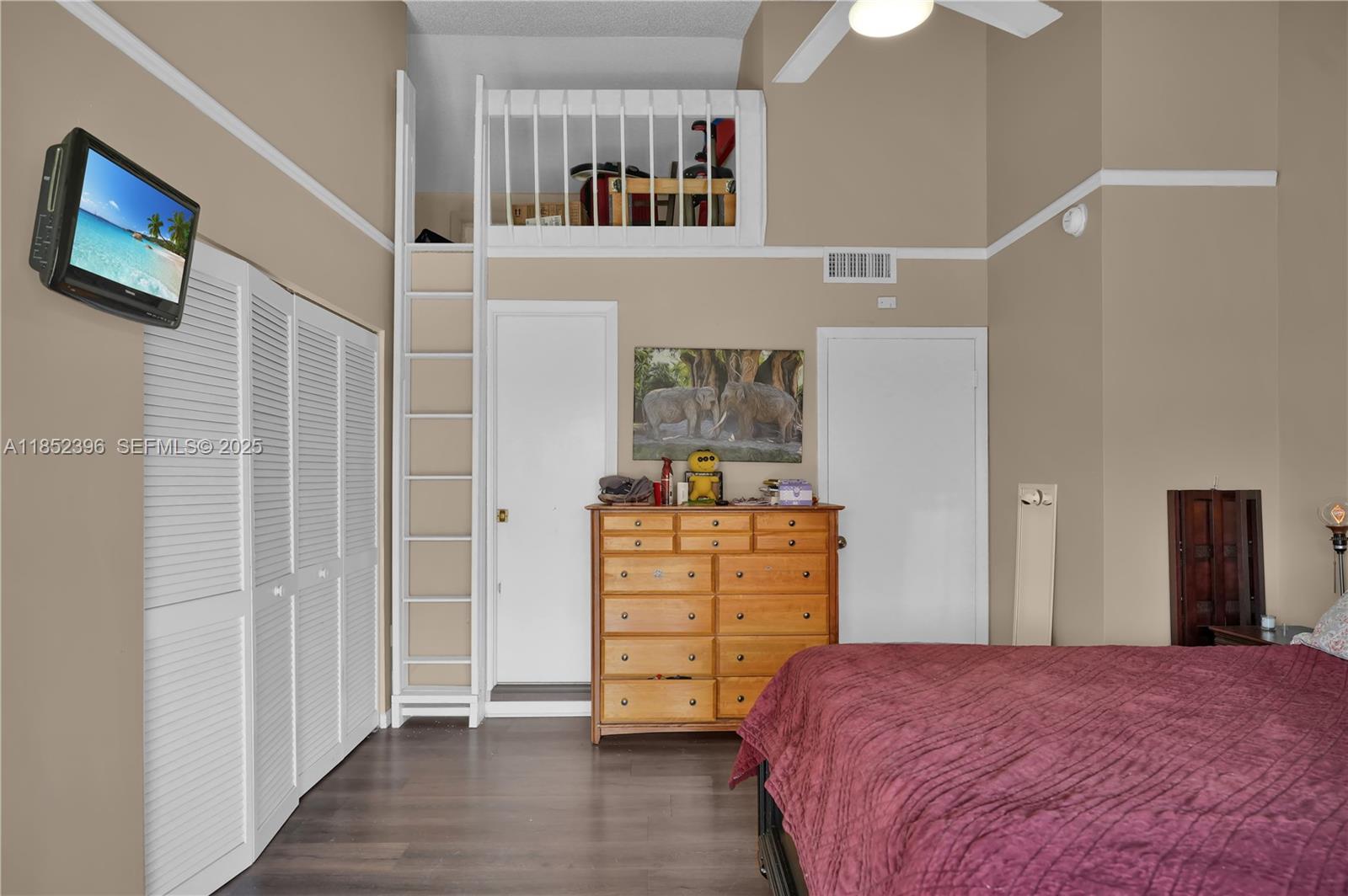 10194 Southwest 77th Court Miami, FL 33156 - Photo 10 of 25 a bedroom with a bed and a cabinets