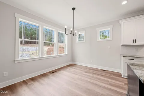 a view of empty room with window and ceiling fan