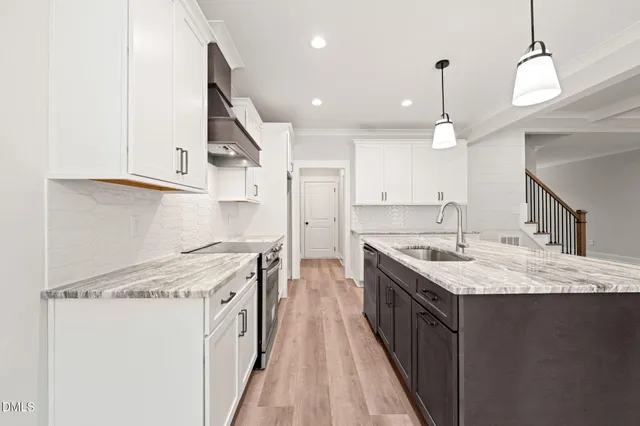 a kitchen with a stove sink and cabinets