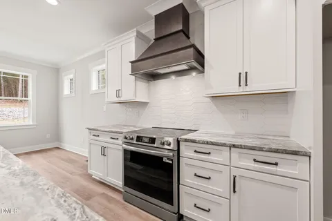 a stove top oven sitting inside of a kitchen