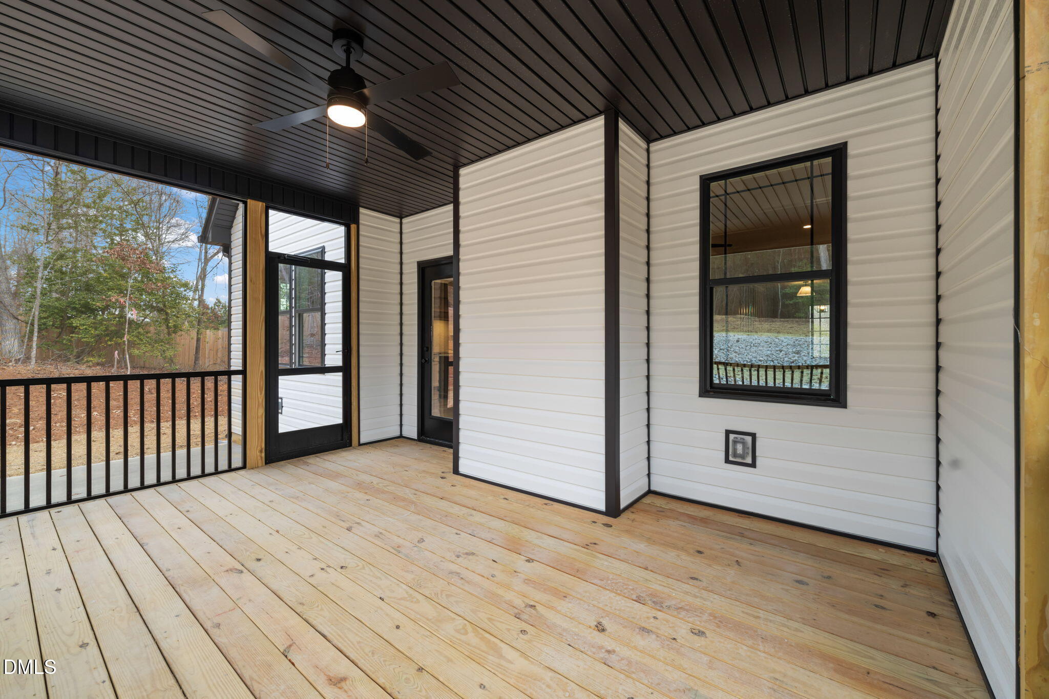 160 Pilot Ridge Road Zebulon, NC 27597 - Photo 38 of 49 a view of a porch with wooden floor and floor to ceiling window