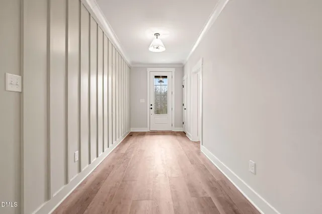 a view of a hallway with wooden floor