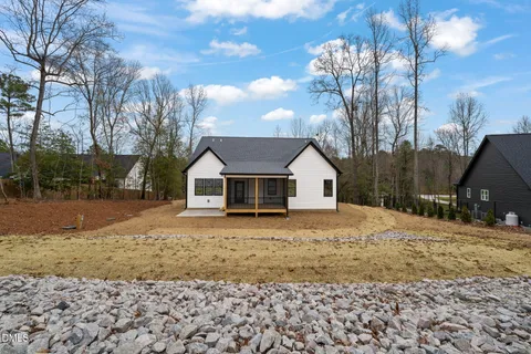 a front view of a house with a yard covered in snow
