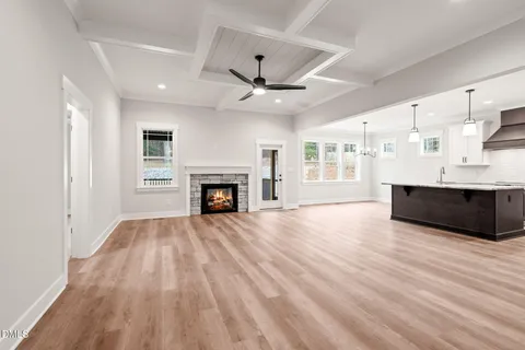 a view of an empty room with a fireplace and a window