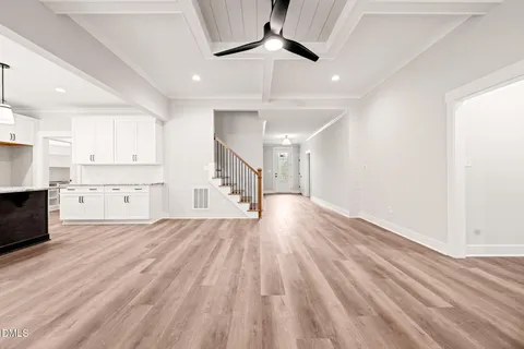 a view of kitchen with granite countertop cabinets and wooden floor