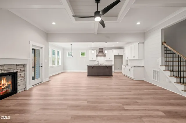 a large kitchen with cabinets wooden floor and a fireplace