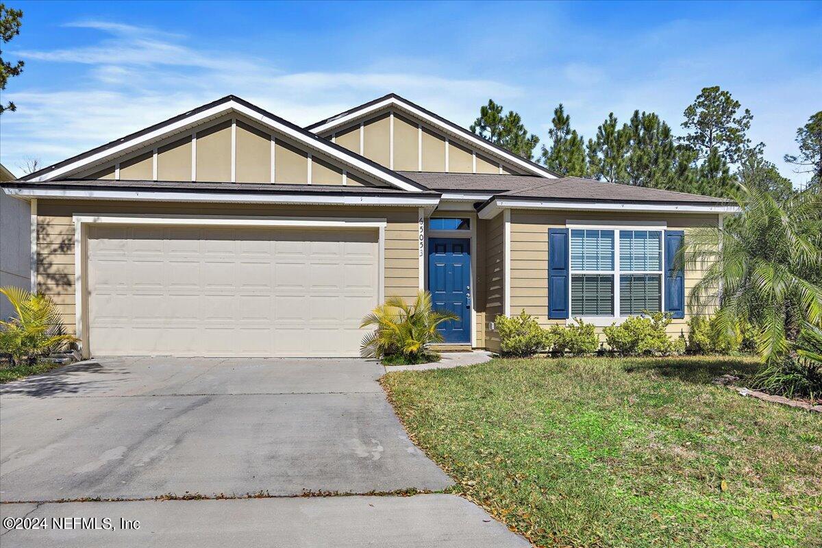 65053 Lagoon Forest Drive Yulee, FL 32097 - Photo 1 of 19 a front view of a house with garden