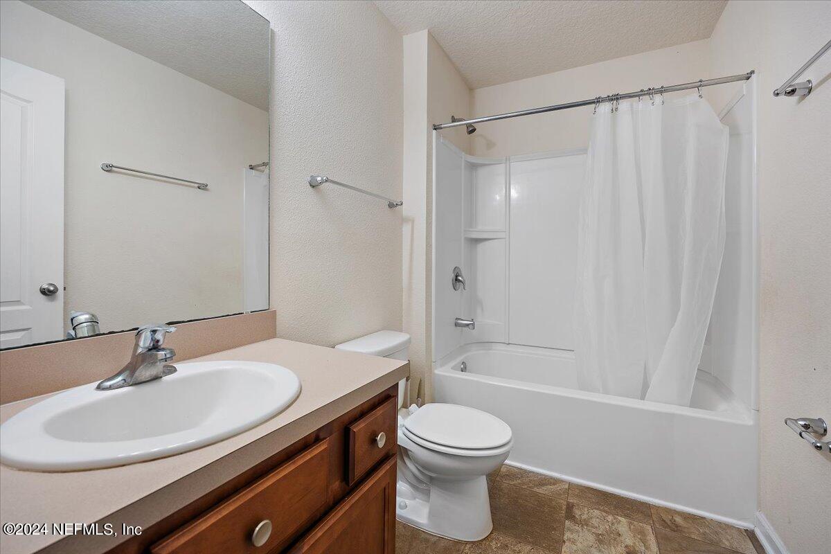 65053 Lagoon Forest Drive Yulee, FL 32097 - Photo 14 of 19 a bathroom with a sink a toilet and shower