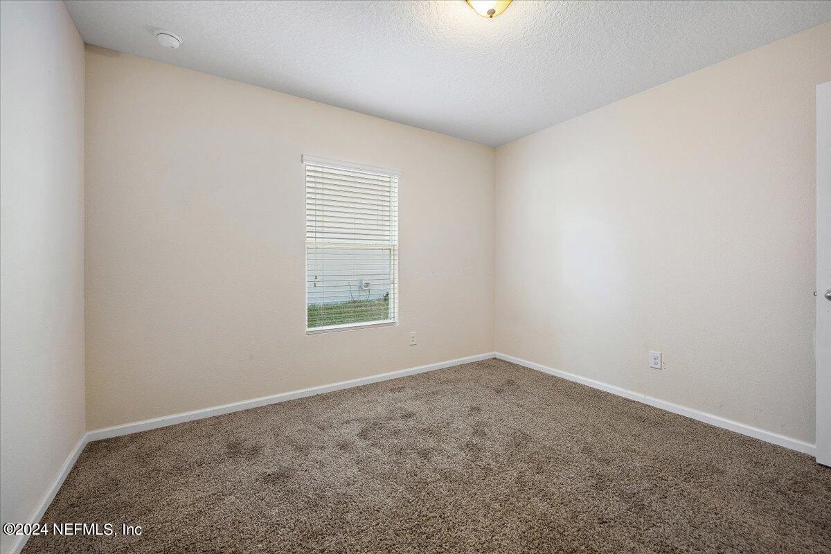 65053 Lagoon Forest Drive Yulee, FL 32097 - Photo 15 of 19 an empty room with a window