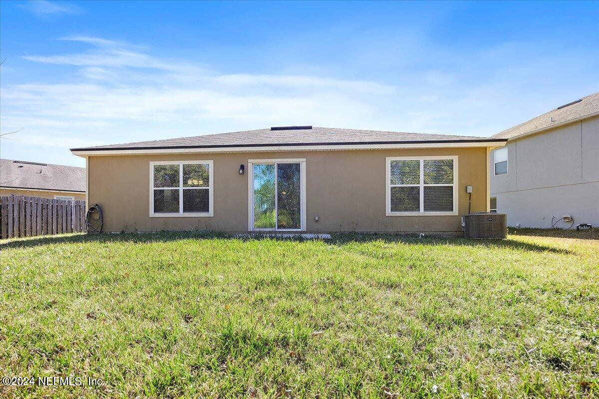 65053 Lagoon Forest Drive Yulee, FL 32097 - Photo 18 of 19 front view of a house with a yard
