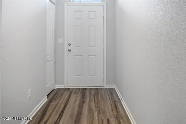 a view of a room with wooden floor
