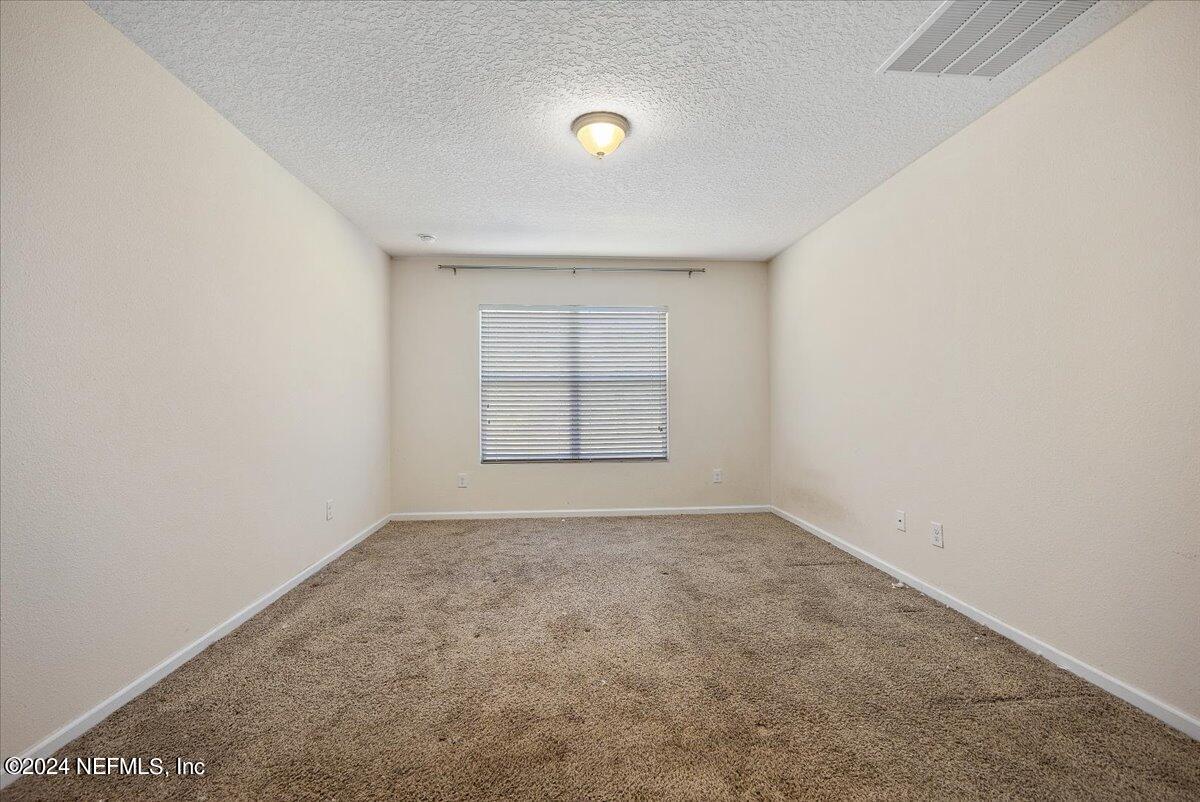 65053 Lagoon Forest Drive Yulee, FL 32097 - Photo 9 of 19 a view of an empty room with a window