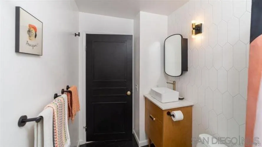 6358 Rancho Mission Road, Unit 624 San Diego, CA 92108 - Photo 11 of 16 a bathroom with a sink and mirror