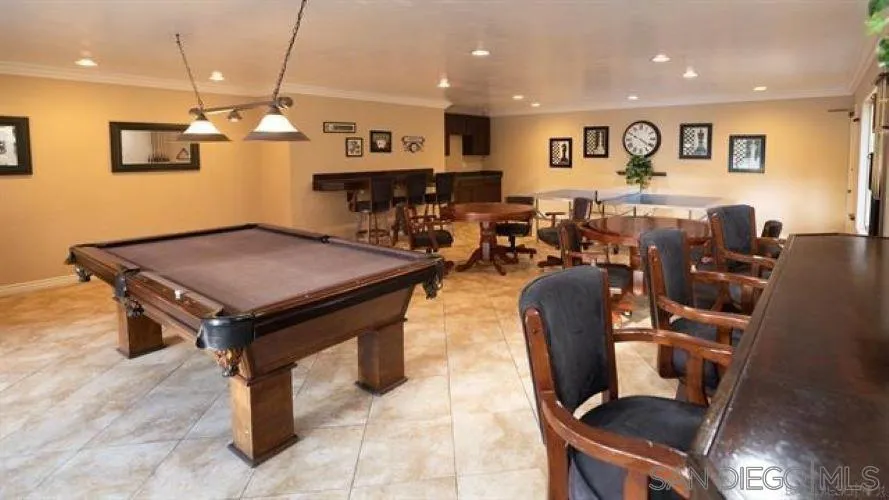 6358 Rancho Mission Road, Unit 624 San Diego, CA 92108 - Photo 15 of 16 a living room with stainless steel appliances kitchen island granite countertop a table chairs and a refrigerator