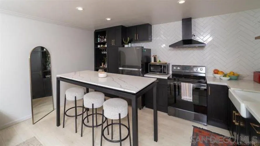 6358 Rancho Mission Road, Unit 624 San Diego, CA 92108 - Photo 2 of 16 a kitchen with cabinets and stainless steel appliances