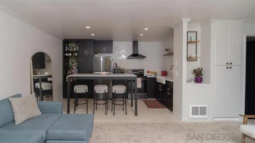 6358 Rancho Mission Road, Unit 624 San Diego, CA 92108 - Photo 3 of 16 a living room with furniture and a dining table with kitchen view