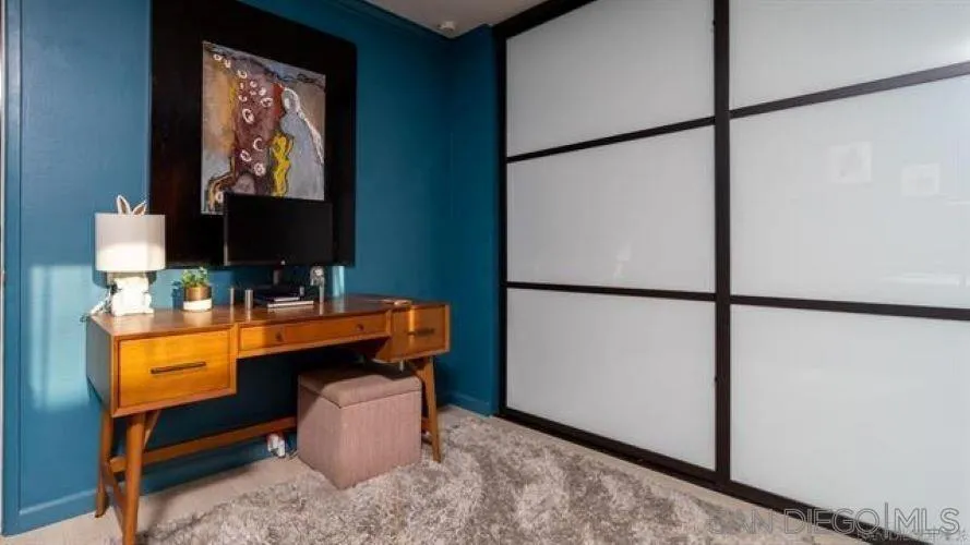 6358 Rancho Mission Road, Unit 624 San Diego, CA 92108 - Photo 6 of 16 a room with furniture and a flat screen tv