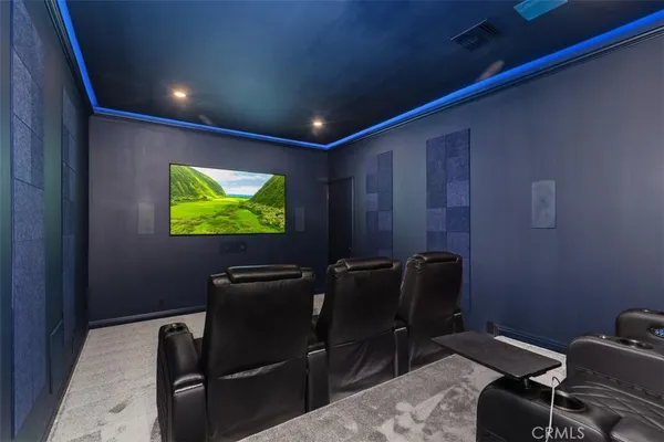 a room with furniture projector and screen