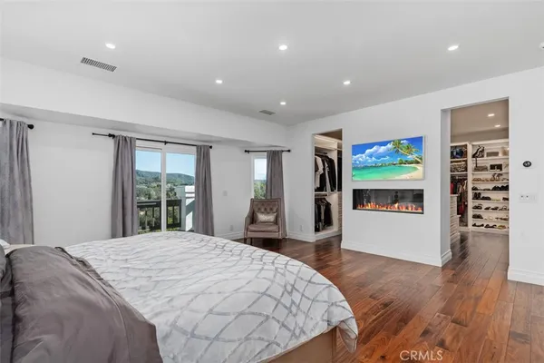 a spacious bedroom with a large bed and a large window