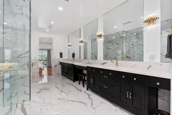 a bathroom with a double vanity sink mirror and shower