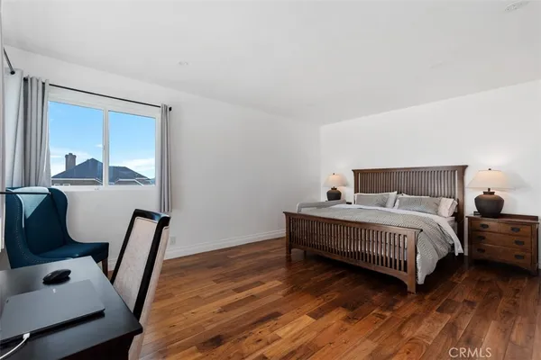a bedroom with a bed a desk and chair