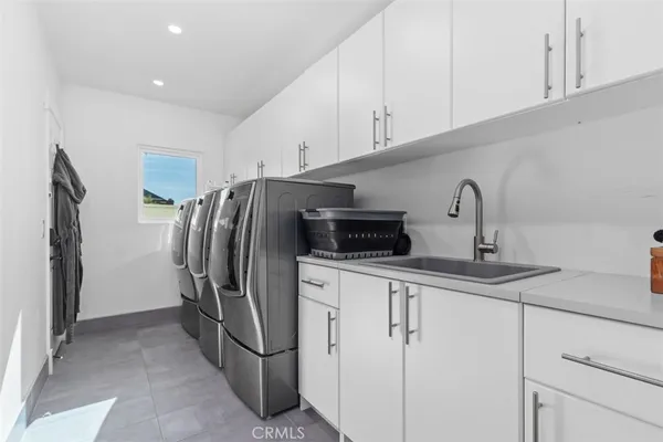 a kitchen with stainless steel appliances a refrigerator sink and cabinets