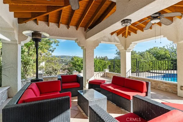 a balcony with furniture and a potted plant