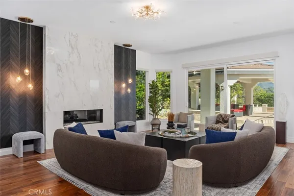 a living room with furniture and large windows