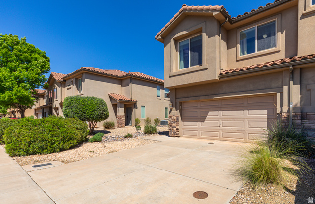 2484 Manzoni Road Santa Clara, UT 84765 - Photo 1 of 27 Mediterranean / spanish-style house with an attached garage, a tile roof, stucco siding, and concrete driveway