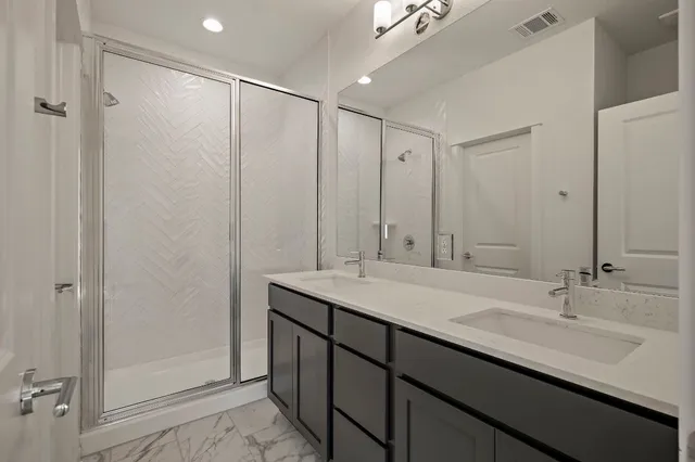 a bathroom with a double vanity sink and a mirror