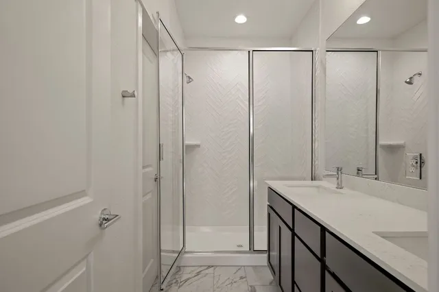 a bathroom with a shower sink and vanity